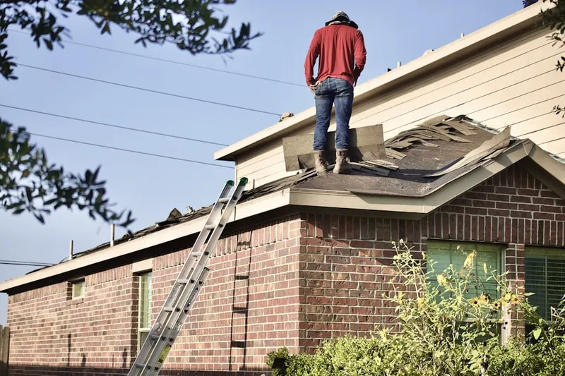Professional roofer working on a residential roof in Baden